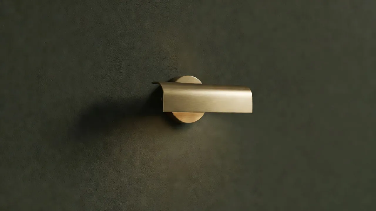 Dark olive green accent wall with a brass sconce light mounted on matte drywall.